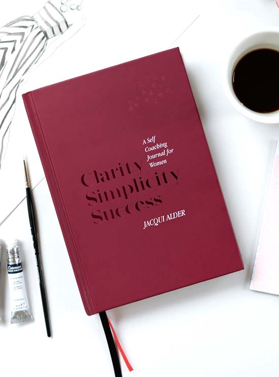 Book display shoring the burgundy coloured front cover of Clarity Simplicity Success A Self Coaching Journal for women by Jacqui Alder